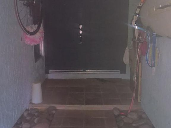 Enclosed gated entry way, perfect to hang bikes and surf boa
