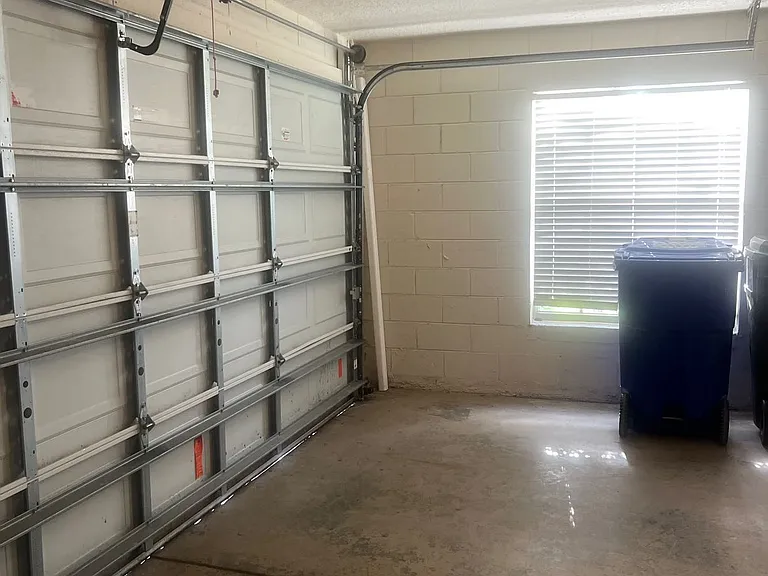 55 - Two-car garage interior with natural light and extra storage space.