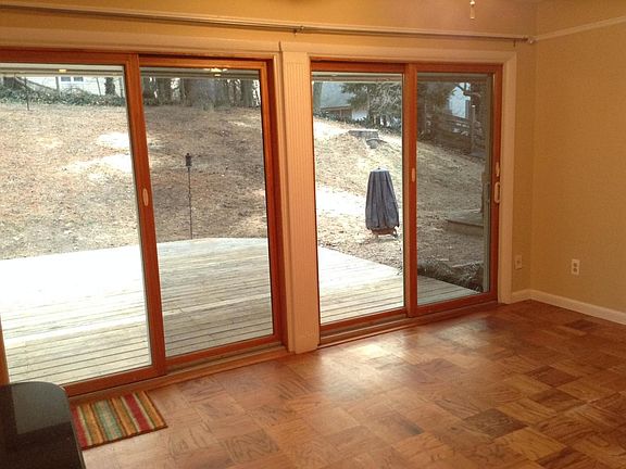 Looking from dining room out back doors to back yard with spacious deck.