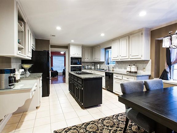Kitchen offers a working island and new back splash and new appliances painted cabinets and much more.
