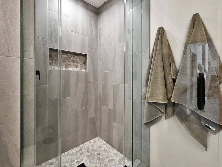 Hallway bathroom walk in shower with built in shelf