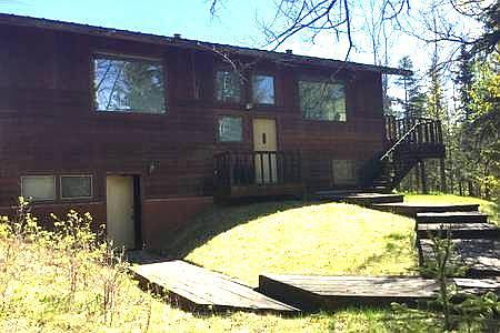 House as seen from the river. The bottom yellow door goes into the garage. The garage door entry is on the other side of the house.