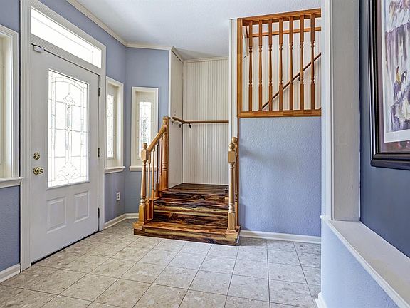 Front entry is light and bright. Recent wood on the stairway and upstairs. There is also a half bath off the entry as well.
