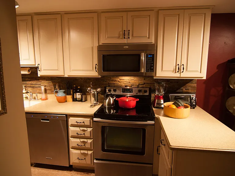 Kitchen with stainless steel appliances and poured counter tops.