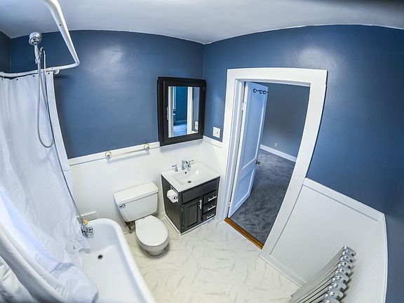 Remodeled bathroom with large claw foot tub.
