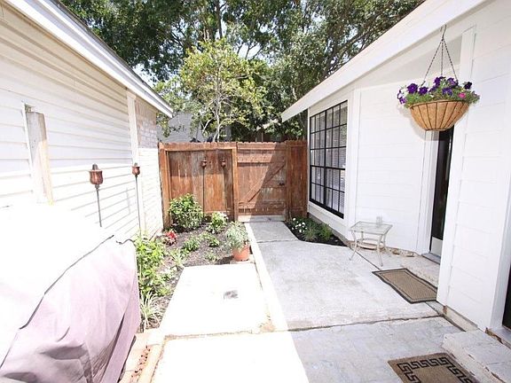 FRONT DOOR BEHIND GATED AREA AND PATIO