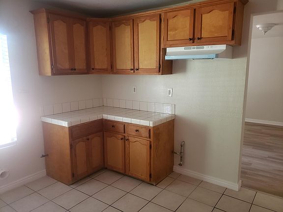 OTHER SIDE OF KITCHEN WITH EXTRA CABINETS