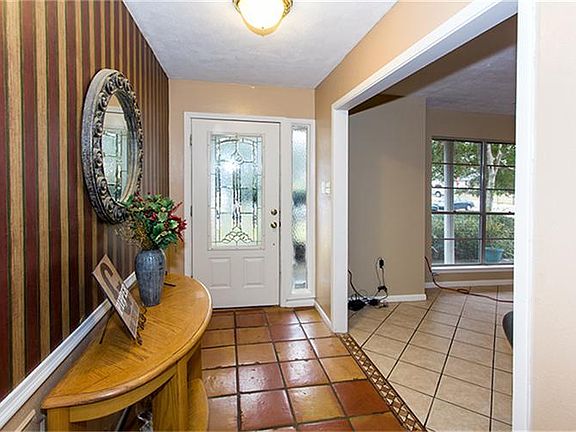 Entry way with leaded glass front entry door and beautiful saltillo tile