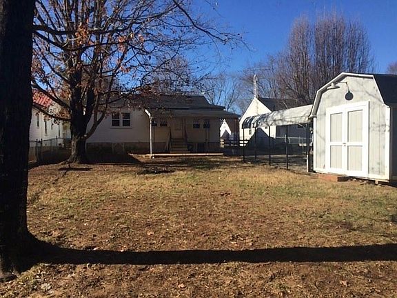 Rear of yard, showing back porch, carport and shed