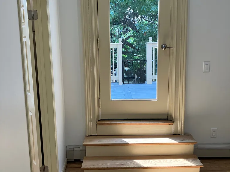 Steps in the bedroom to the deck outside