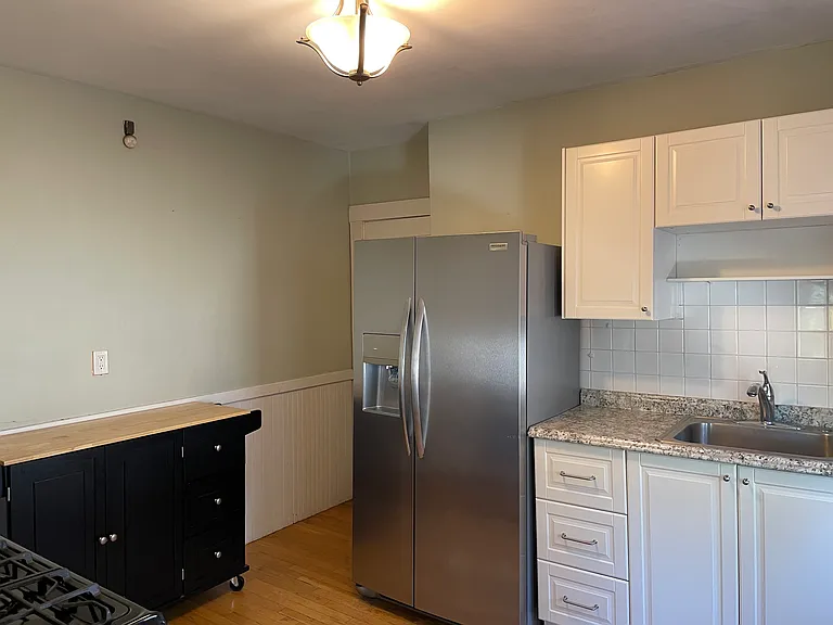 Kitchen w large fridge, gas oven, newer cabinets