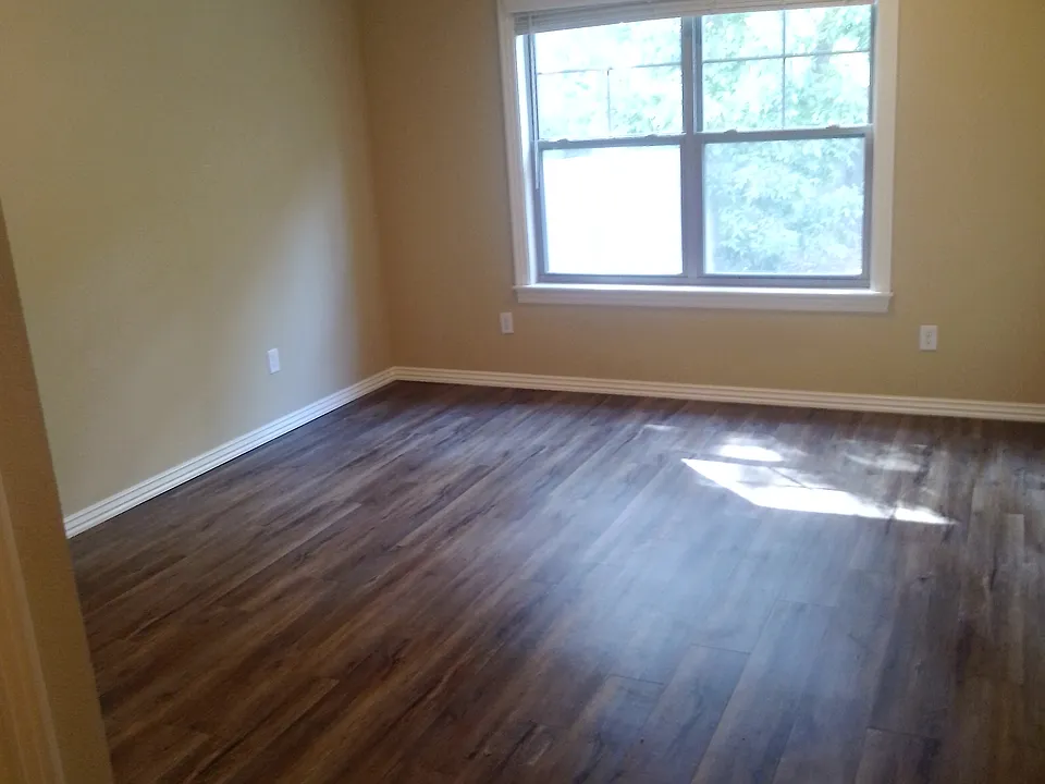 Spacious master bedroom with fan and walk in closet.