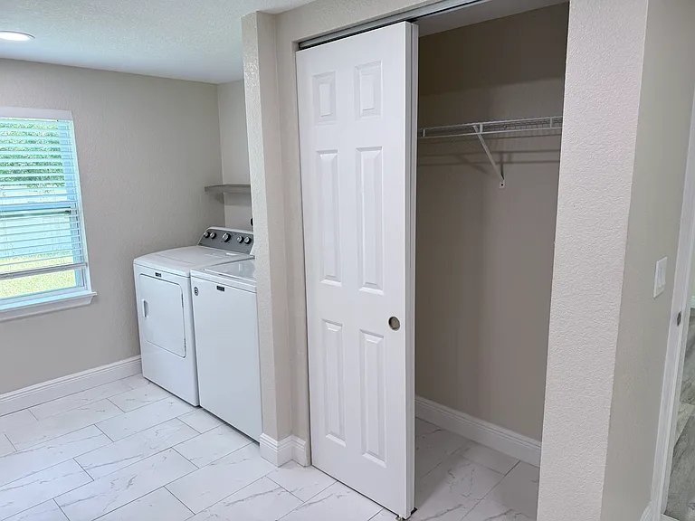 Master bath with washer dryer and extra closet