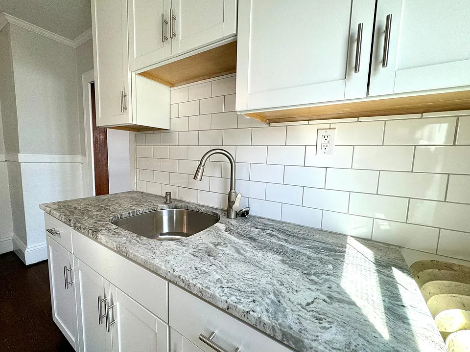 New cabinets, quarts countertop, stainless moen faucet