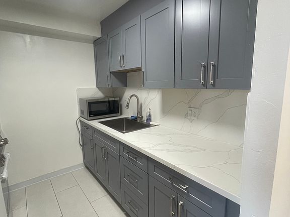 Newly installed kitchen cabinets and sink.