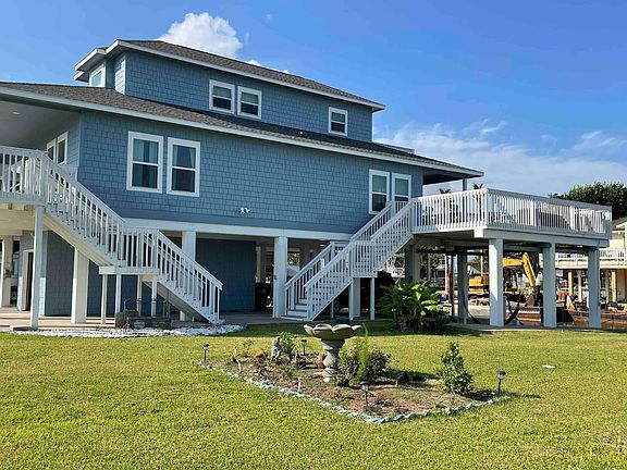 side view, front and rear stairs leading to second level.