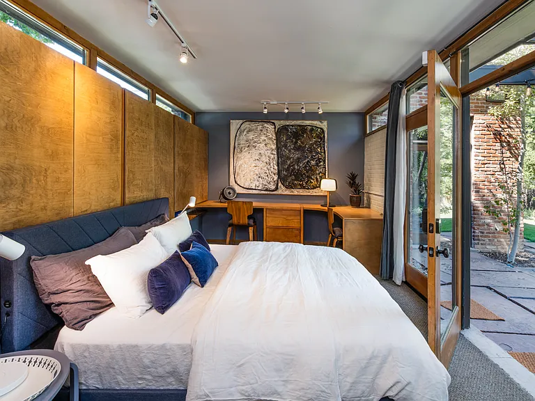 Back Bedroom with lots of desk space and door to another patio. Used to be single car garage. very private space