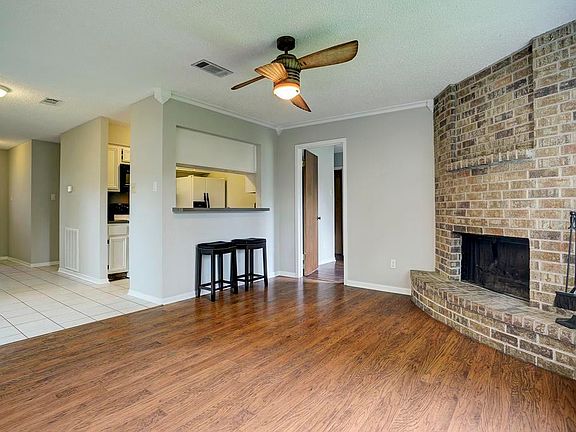 The kitchen is open to the living room and dining areas. The front entryway is shown here to the left.