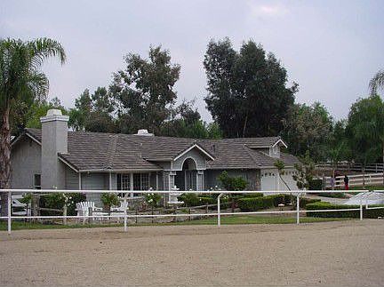 1.8 acre Ranch house, lush landscaping, beach entrance pool, barn, arena. 