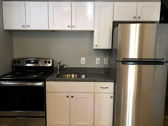 New kitchen with granite counters, stainless appliances, garbage disposal.
