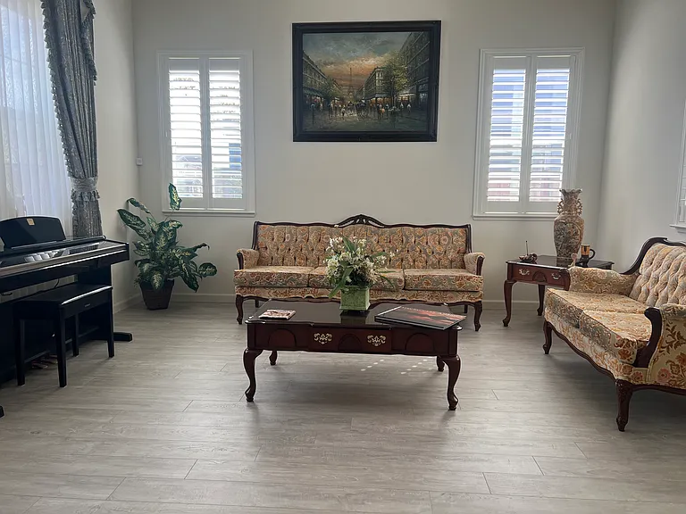 Formal Living room with high ceiling and draperies