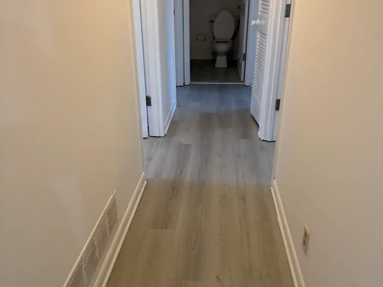 hallway leading to bedrooms. 2 rooms on the right and 2 rooms on the left. master bed room is the 2nd room on the left