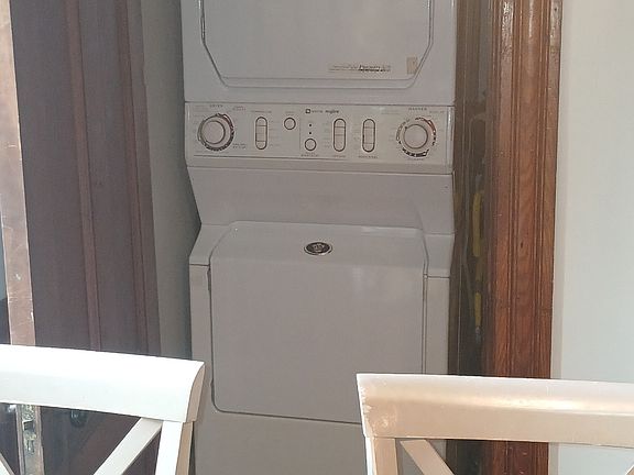 Laundry area featuring Maytag 'Neptune' washer & dryer. There is additional storage in laundry area.