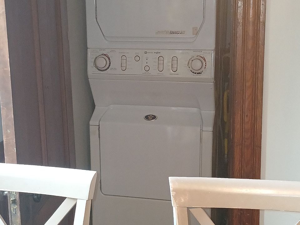 Laundry area featuring Maytag 'Neptune' washer & dryer. There is additional storage in laundry area.