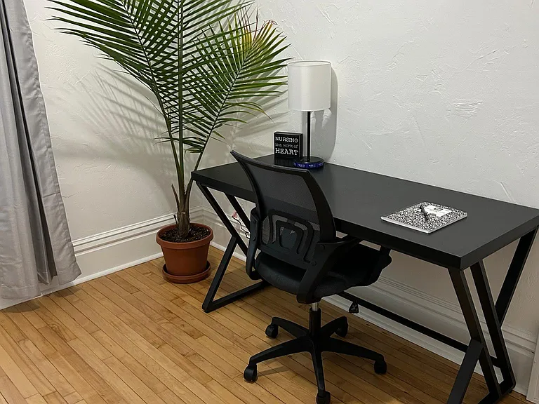 A desk and chair in your private unit. (washer and dryer is also in this room)