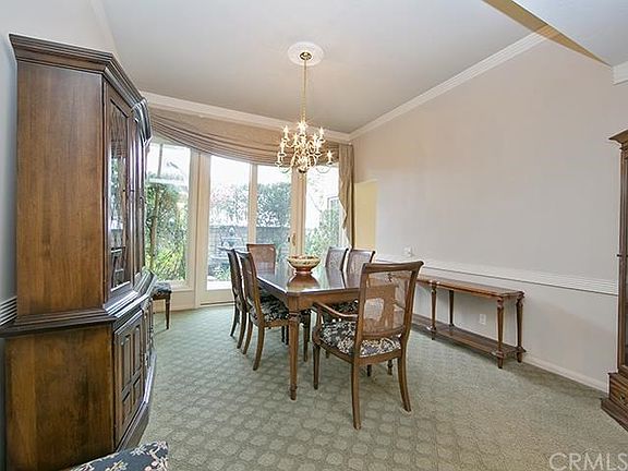 Separate formal dining room with oversized slider leads out to the side courtyard
