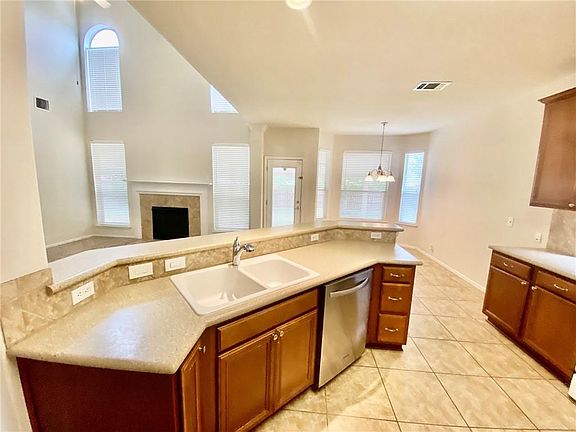 Kitchen Sink Overlooks Living Area with Views of Backyard