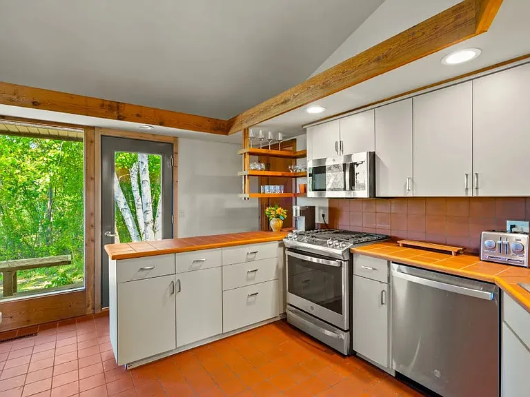 A bright, modern kitchen with stylish cabinetry, updated stainless-steel appliances, and an open layout perfect for cooking and entertaining.
