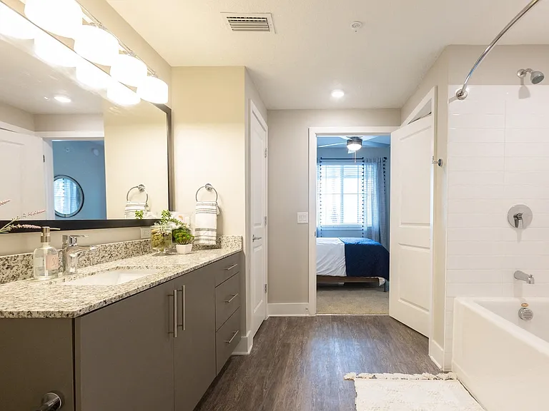 Large mirror vanities and plentiful storage in bathrooms.