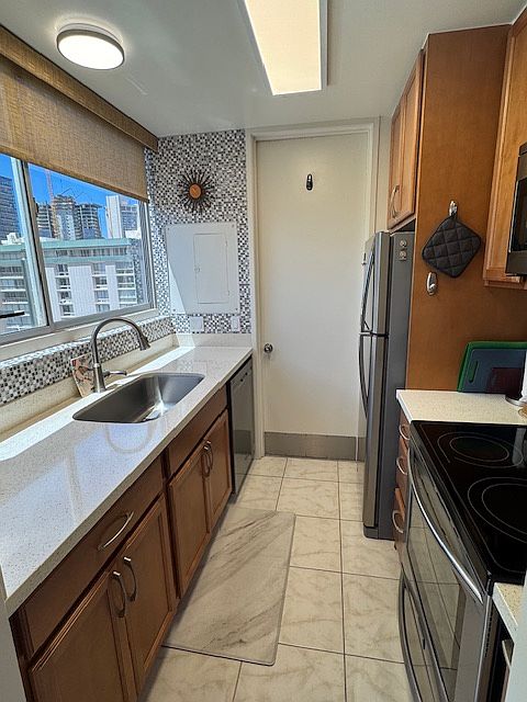 Fully-equipped kitchen. Has all dishware, cooking utensils and cookware, Also, storage containers for use. Door leads to the small patio and to bedroom door.