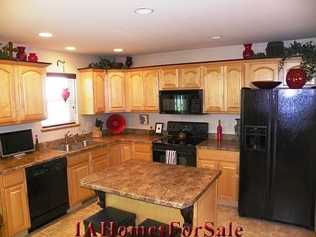 Kitchen: Maple cabinets with cherry trim, custom wood blinds, large pantry and storage closet. All appliances included