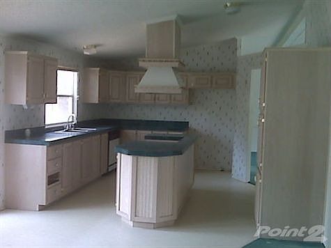 kitchen has an island for additional workspace