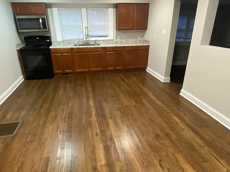 Picture of the kitchen from the back door. Very large space with room for island or table and chairs. Some have used the wall to the right as where they set up a home office/work space.
