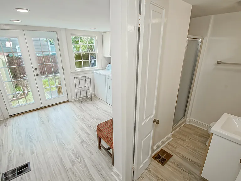 Downstairs bathroom and laudry room at rear of home.