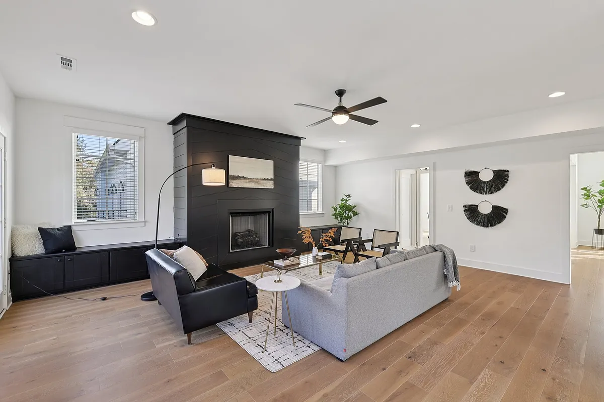 Open living area with fireplace feature wall, hardwood floors, and natural light throughout. - 521B Hobson Chapel Pl #B