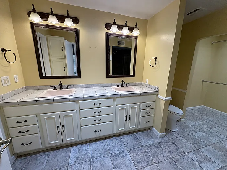 Master bath with two closets and walk-in shower