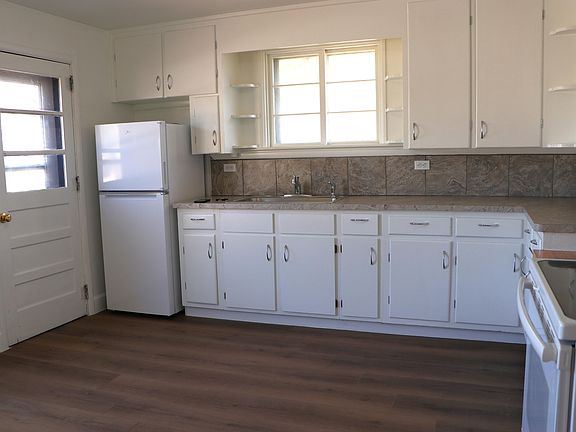 Bright kitchen features a side entrance and so much storage!