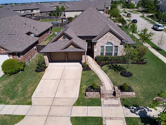 A birds eye view shows a long driveway that is sure to provide ample parking!