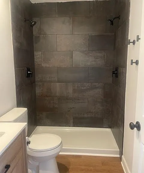 Newly renovated tile shower with duel shower heads.