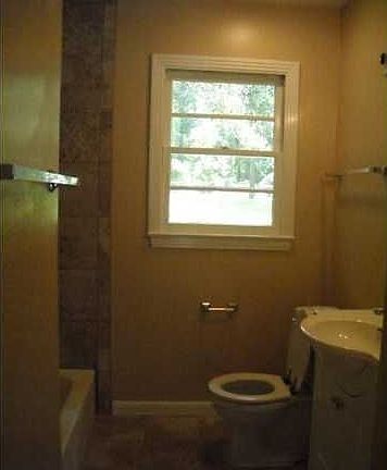 Updated bathroom with ceramic tile floors and bath