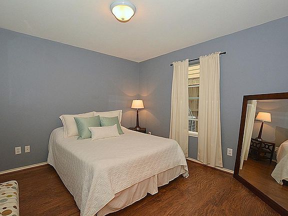The downstairs bedroom features wood floors, a large walk in closet and private bath!