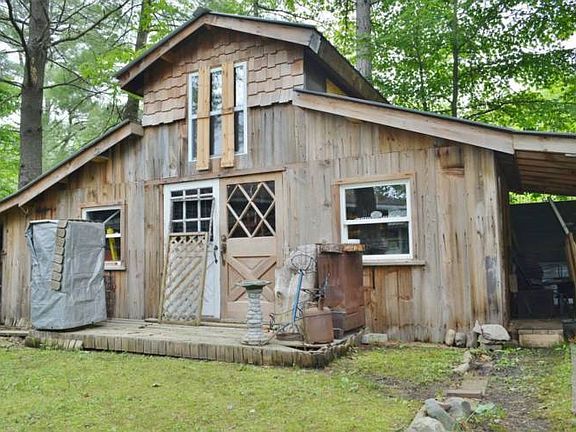 Art studio/workshop with attached wood storage area.