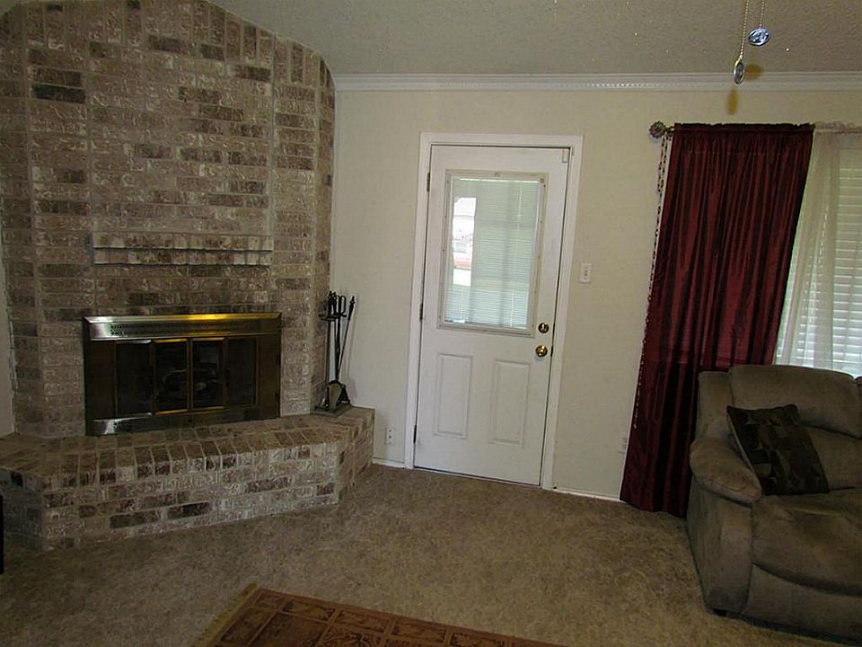 The beautiful brick fireplace is the focal point of the den