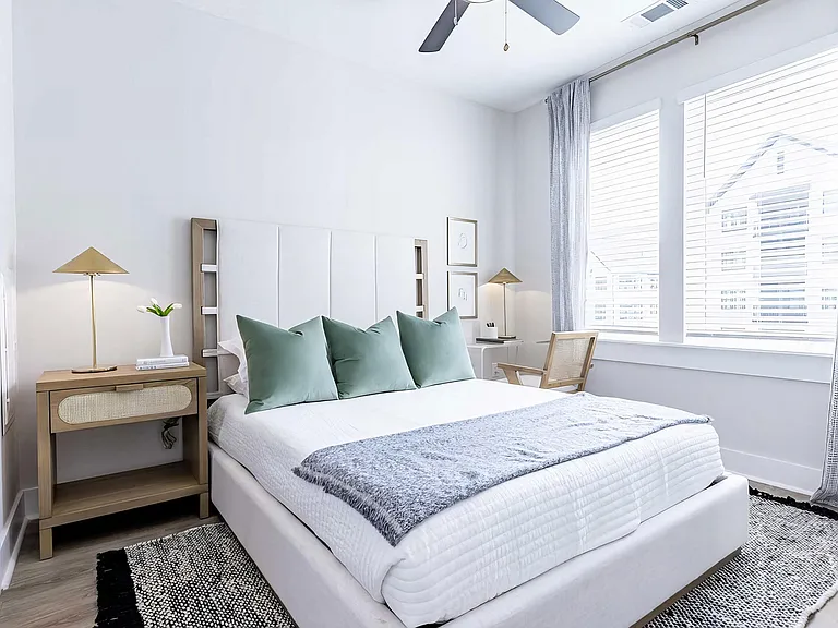 Large bedroom with oversized white trim and abundant natural light