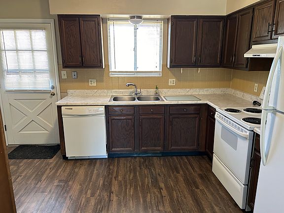 Kitchen with back door to green space.