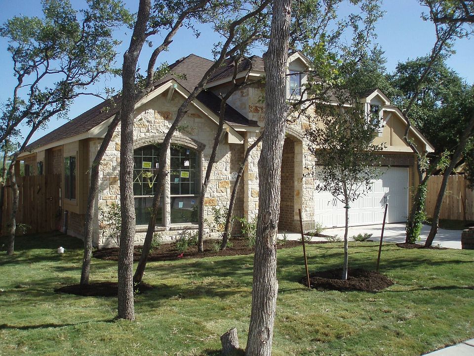 Stone with brick accents and trees add to curb appeal